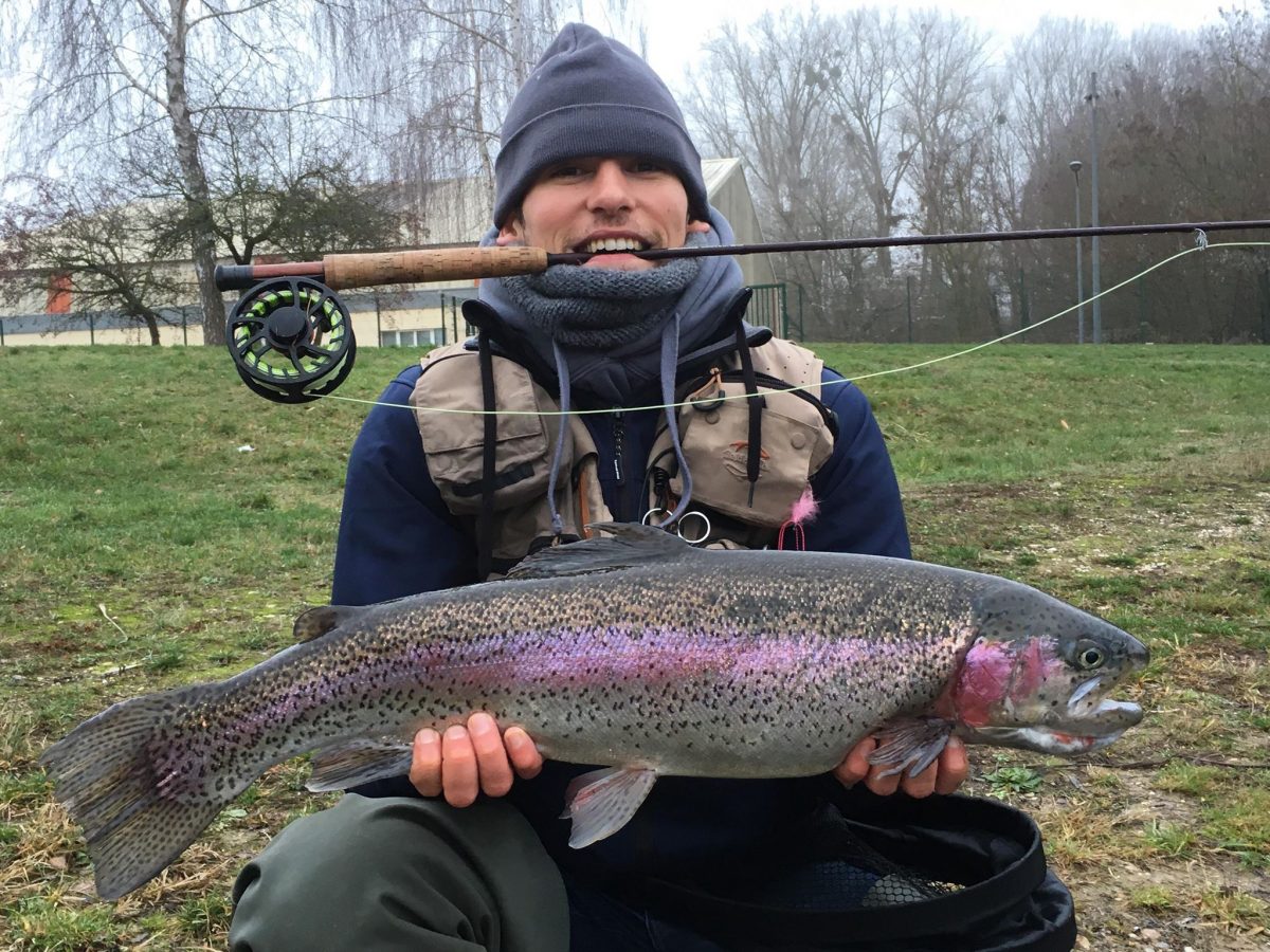 a happy flyfisherman with a really big trout from the stork reservoir in Seltz